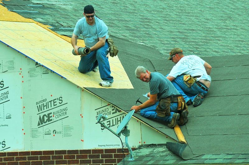 Roofers repairing a roof after a tornado